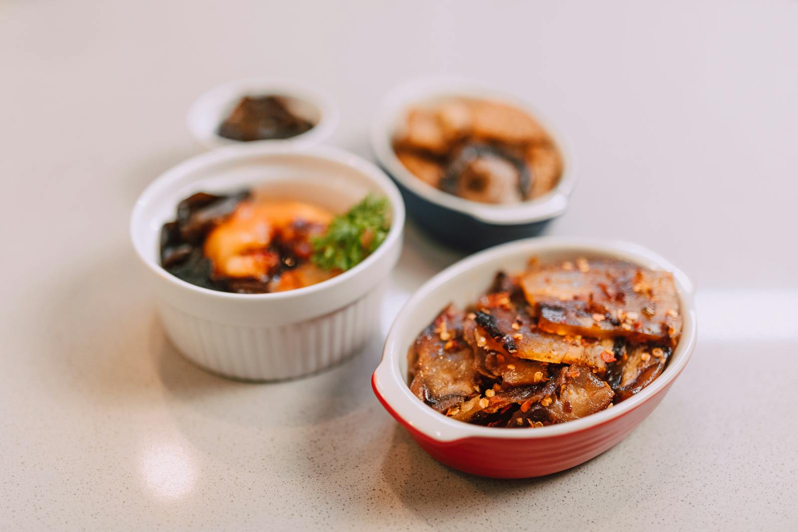 Appetizing Korean side dishes in ceramic bowls, perfect for food photography.